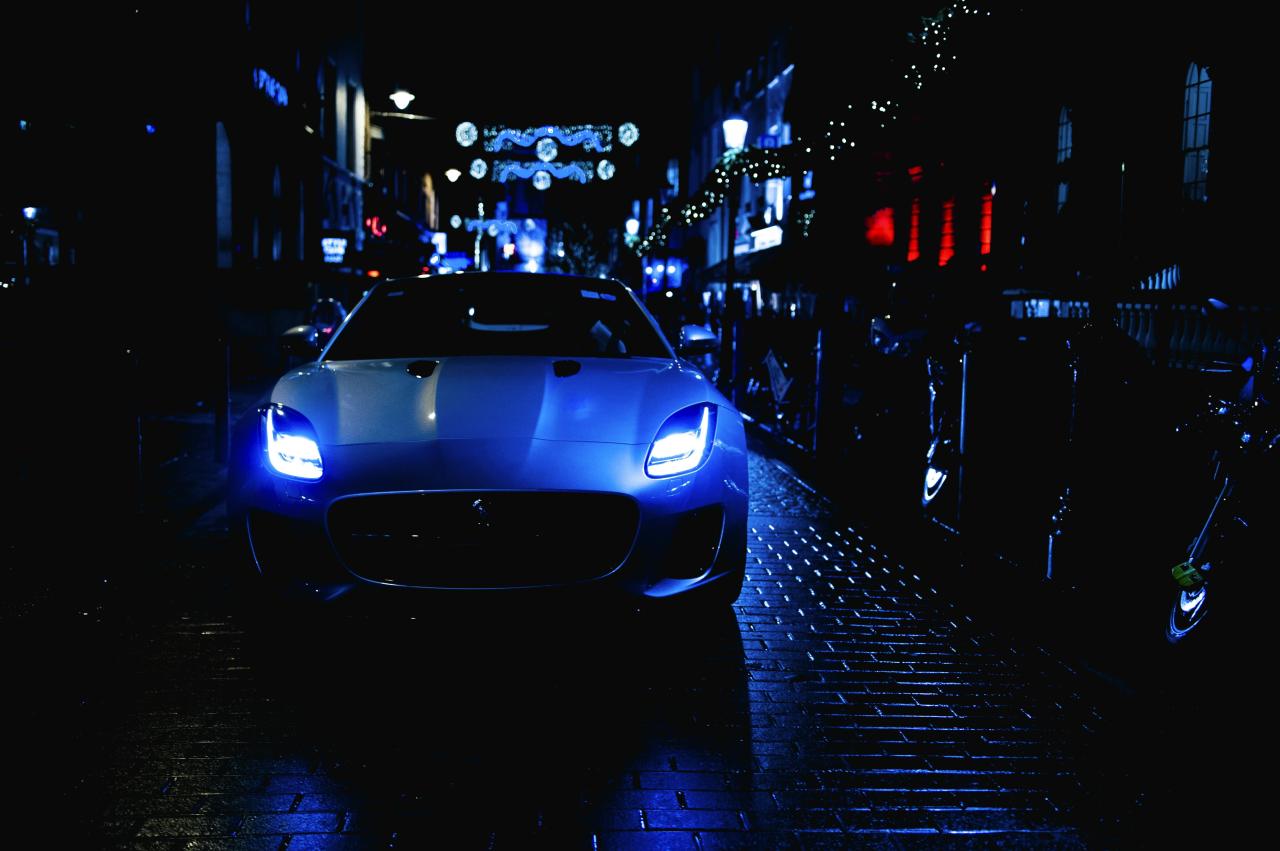 silver car parked on sidewalk during night time