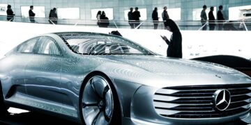 man in black suit standing beside silver mercedes benz coupe